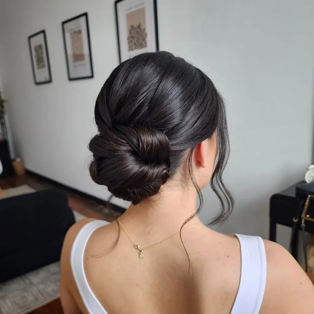 15 Hairstyles With Bangs That Instantly Make You Look Cooler 11 Low Bun With Face Framing Bangs