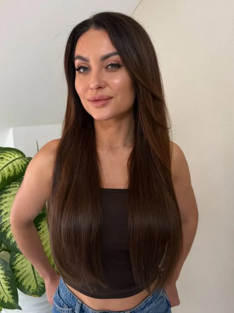 15 Round Face Hairstyles Ideas That Make Your Features Look Extra Chic 8 Sleek Straight Hair With a Middle Part