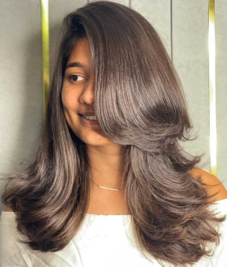 15 Hairstyles With Bangs That Instantly Make You Look Cooler 15 Voluminous Blowout With Side Swept Bangs