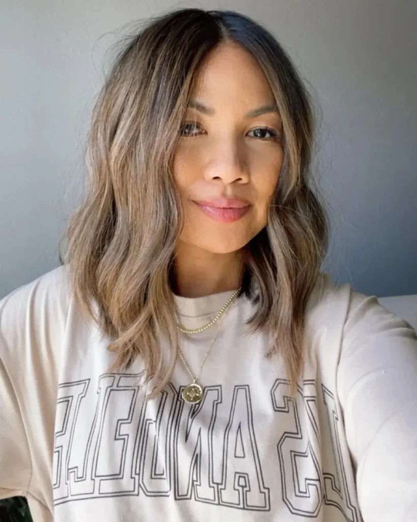 15 Hairstyles With Bangs That Instantly Make You Look Cooler 12 Wavy Lob With Curtain Bangs