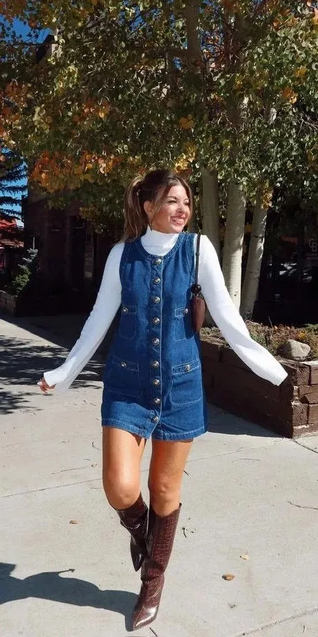 16 Denim Dress Outfit Ideas That Make Getting Dressed Look Effortlessly Cool 11 Sleeveless Denim Dress over a Turtleneck