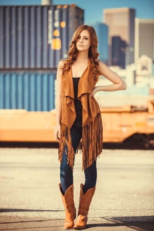 16 Boho Fall Outfits That Bring Cozy Free-Spirited Style to Autumn Days 12 Fringe Vest With Jeans and Boots